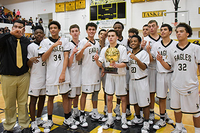 boys holding up trophy