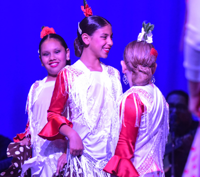 girl in flamenco outfit smiling