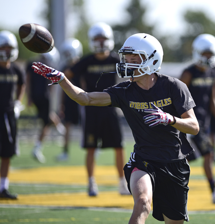 football player tossing ball