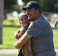 father hugging daughter