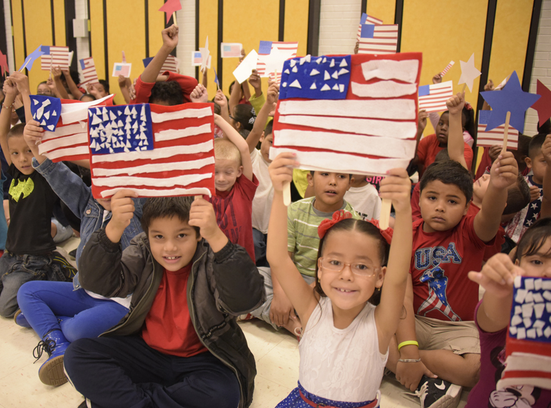 kids holding up flags