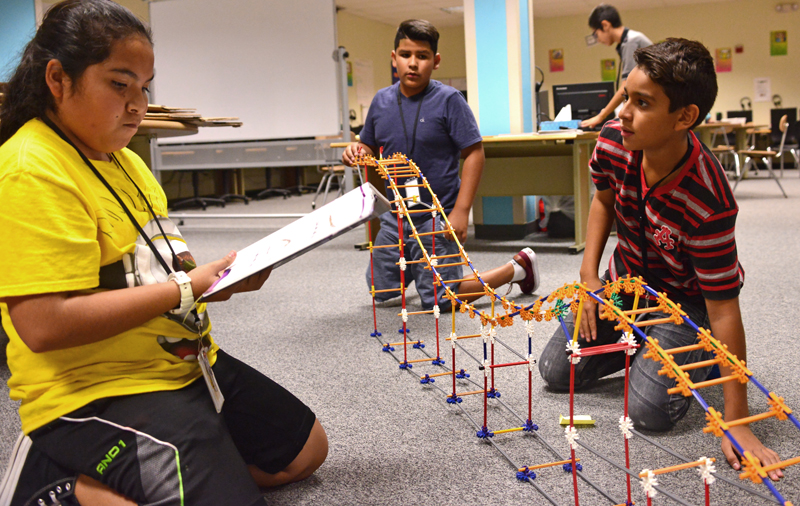 kids putting together roller coaster kit