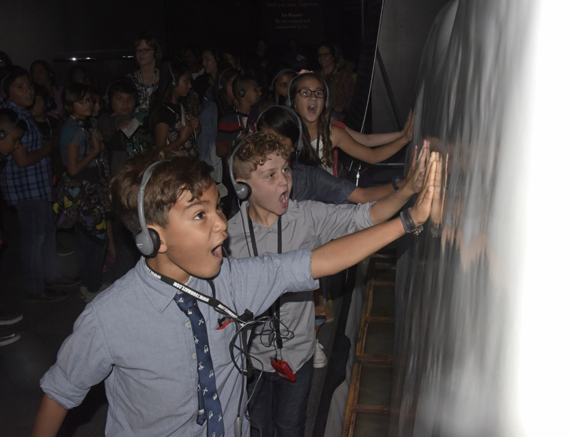 kid touching fake iceberg