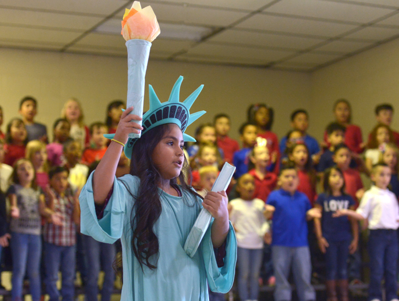 student holding statue of liberty