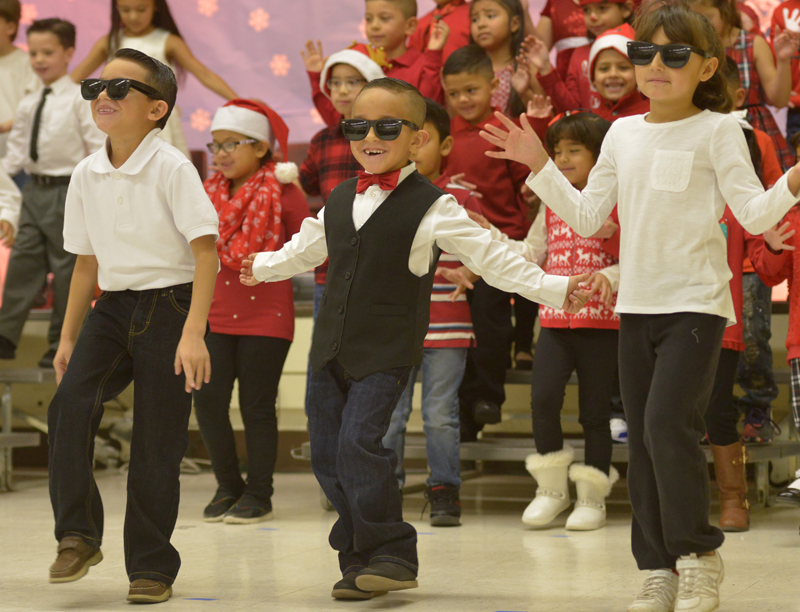 students dancing in christmas outfits