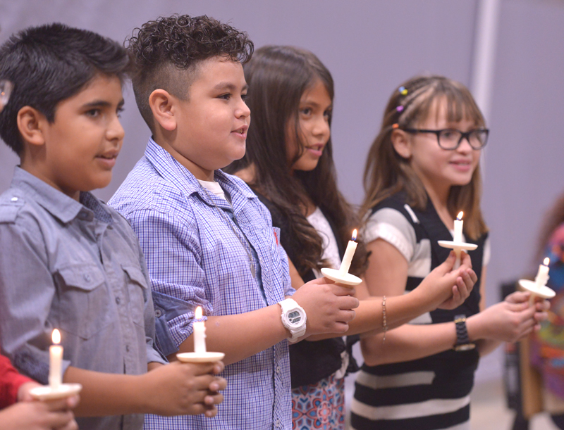 students holding candles