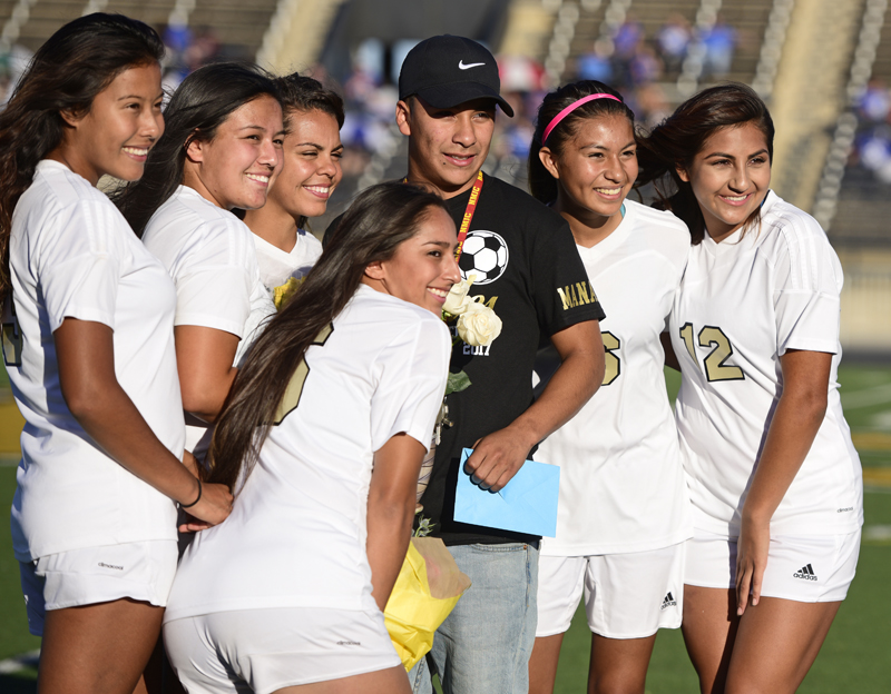 soccer players standing with team manager