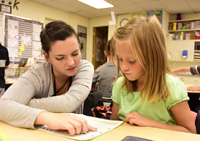 teacher helping student