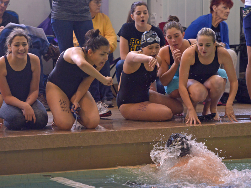 swimmers on edge of pool cheering