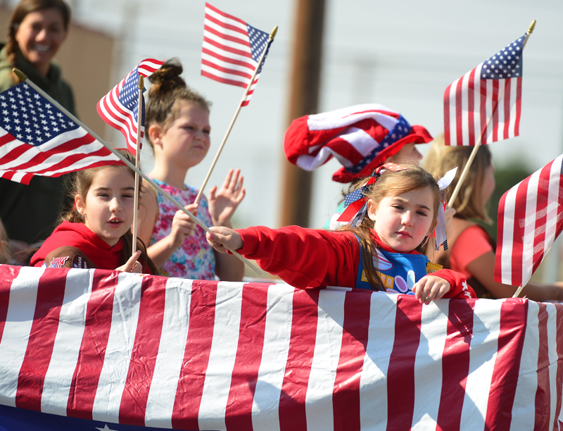 girl waving from float