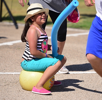 girl sitting on bouncy ball