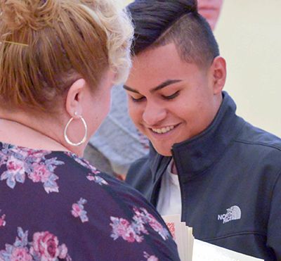 teen smiling while getting award