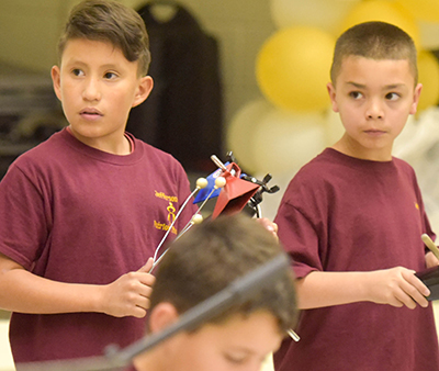 two students with musical instruments