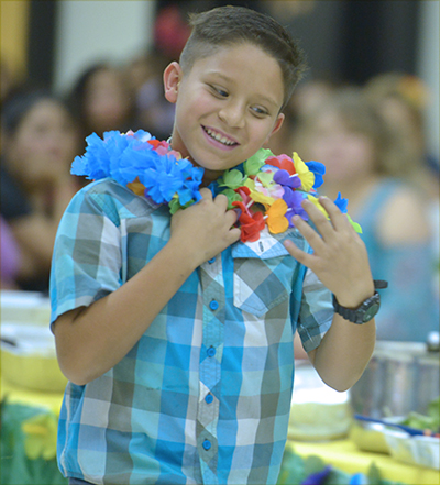 student in lei smiling