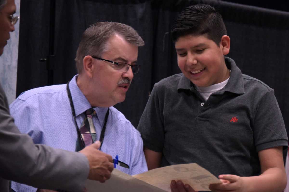 smiling student receiving certificate