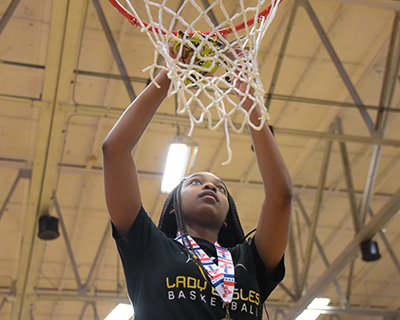 player cutting down basketball net