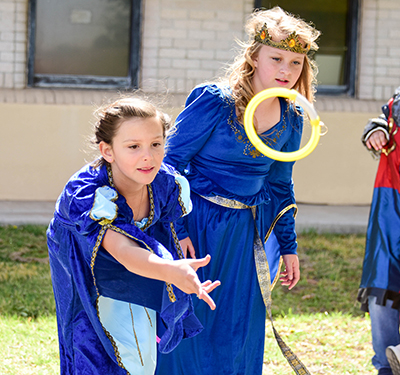 girls in princess dresses tossing rings