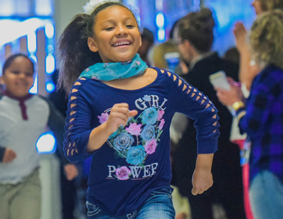 girl running in hall while smiling