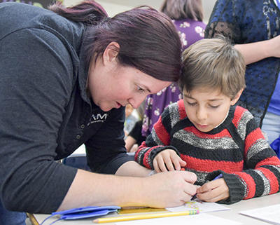 mom helping son with craft