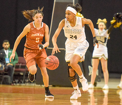 player running up court dribbling