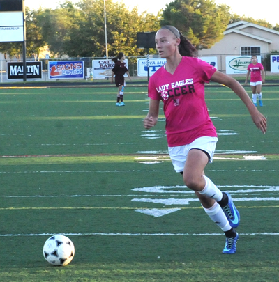 player chasing a soccer ball