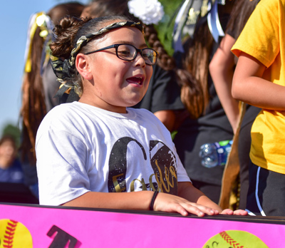 girl in back of truck at parade