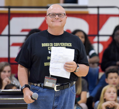 Coach Andy Sloan standing in gym