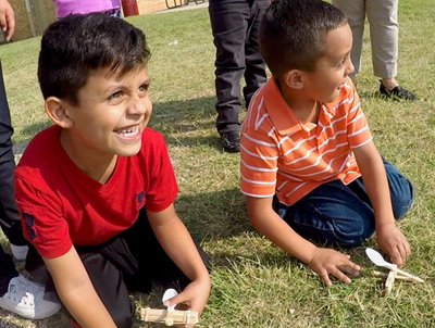 two kids getting ready to launch catapault