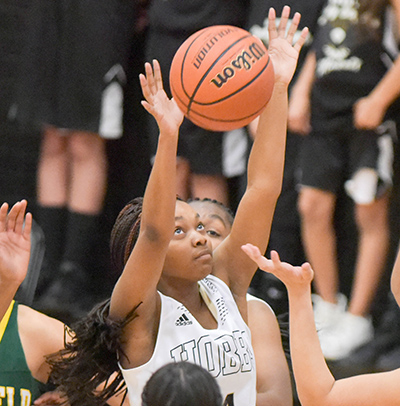 girl going for basketball rebound