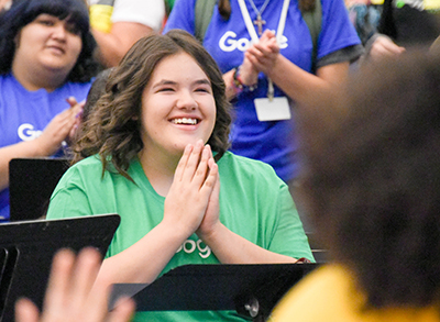 girl clapping hands in surprise