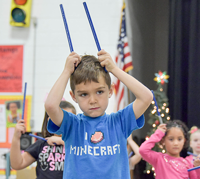 boy with sticks on either side of his head