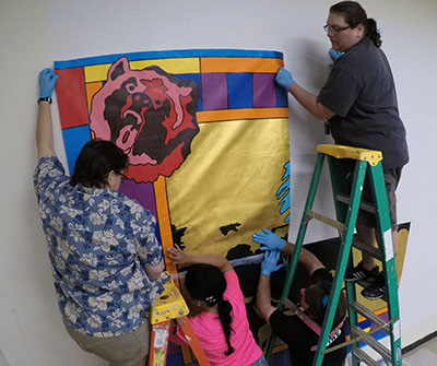 teachers hanging mural