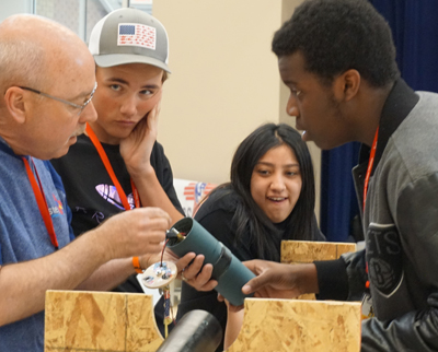 three students looking at judge