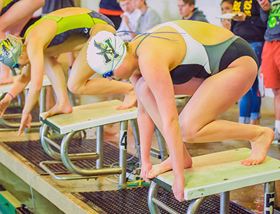 girl getting ready to go off diving blocks