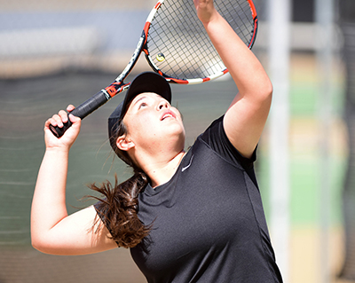 girl getting ready to serve tennis ball