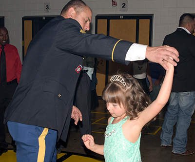 dad twirling daughter on dance floor