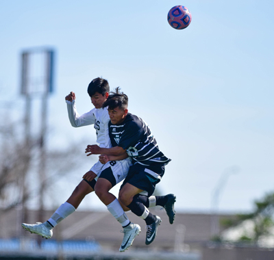 2 players going for ball in air