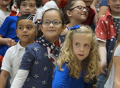 three girls in red white and blue dancing