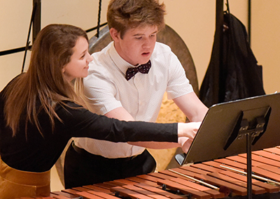 boy and girl looking at music