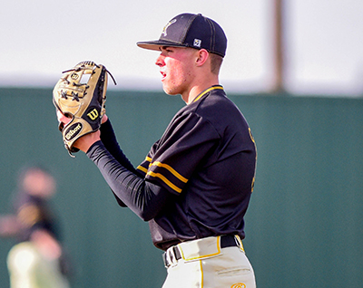 pitcher with ball in glove looking at home plate