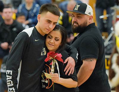 player hugging mom and giving her a flower