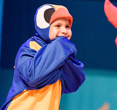 kid in parrot costume laughing