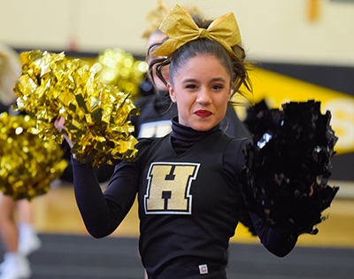 girl with pom poms smiling