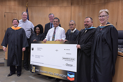 school board holding oversized check