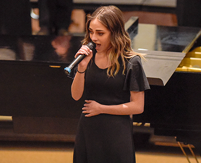 girl singing with microphone