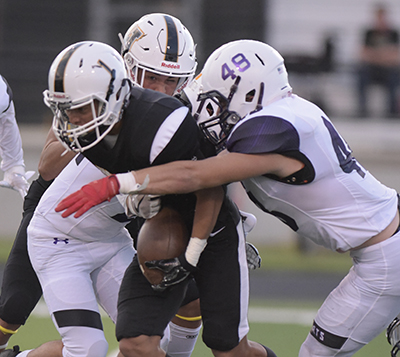 eagle running back surrounded by tacklers