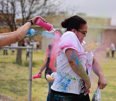 adult getting squired with colorful chalk