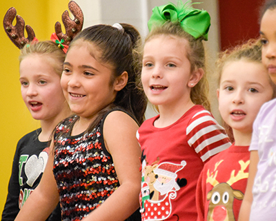 girls in christmas dresses singing