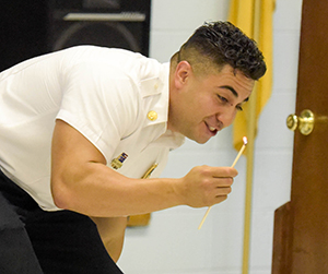 fireman bending over with lit match