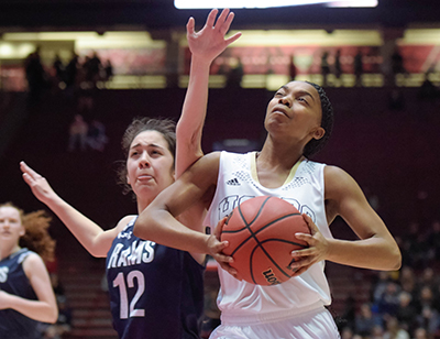 player squinting as she goes up for ball